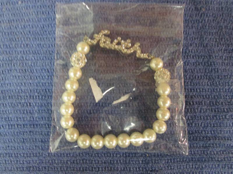 lot 12 image: Faith faux white pearl bracelet...