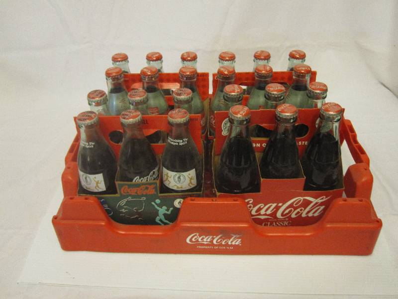 lot 52 image: 4- 6 packs of full unopened collectible Coca Cola bottles