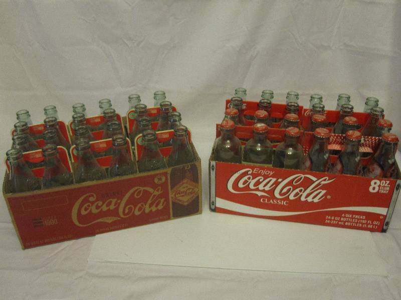 lot 54 image: 2 cases of empty Coca Cola commemorative bottles