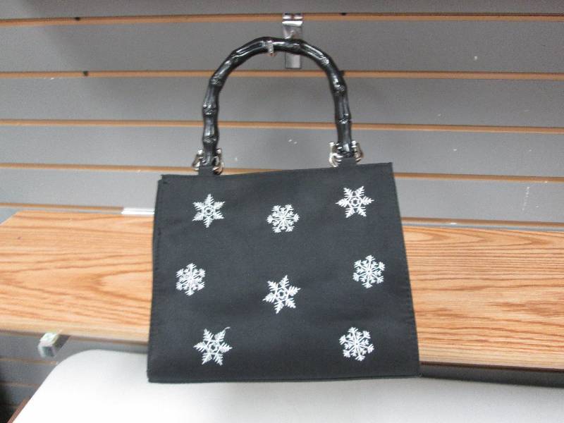 Black fabric with snowflakes purse...
