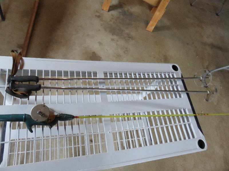 vintage fishing pole and ski poles