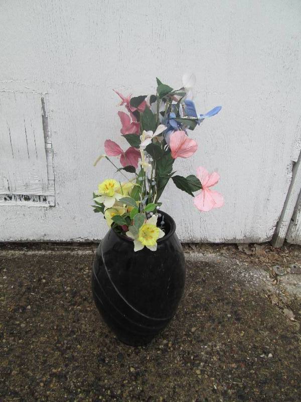 large black vase with arificial flo...