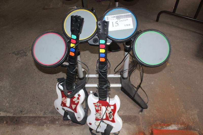 lot 15 image: Lot of (3) Playstation Accessories Including Guitar Drum Kit Pedals