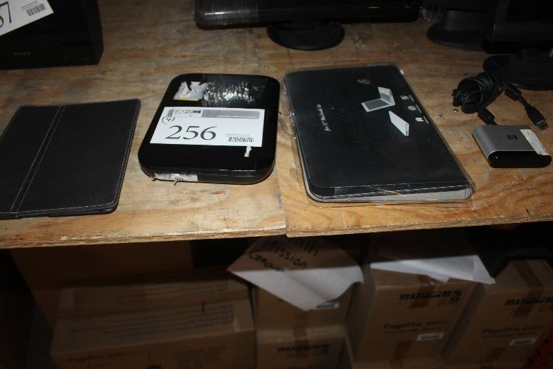 lot 256 image: Lot of (4) Electronic Equipment Including HP Print Server 11 Macbook Air Protector Targus THD006-51 Protector Logitech Revue