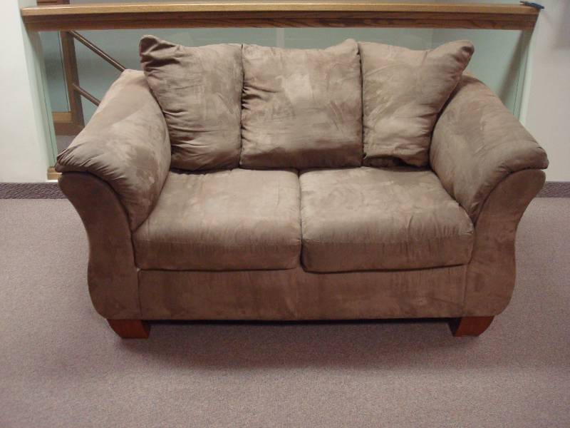 lot 1 image: Micro Fiber Love Seat Couch, Minor Wear, A Few Minor Marks, Tiny Tear Under One Couch