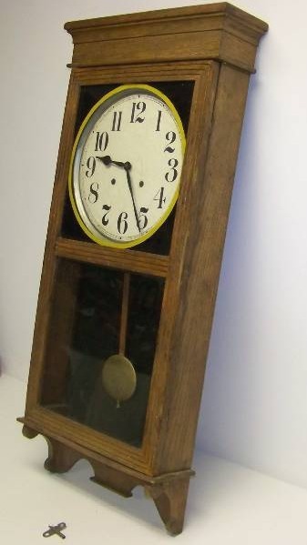 lot 2 image: Ingraham, Store Regulator, Antique, Wall Hanging Clock with Key and Pendulum