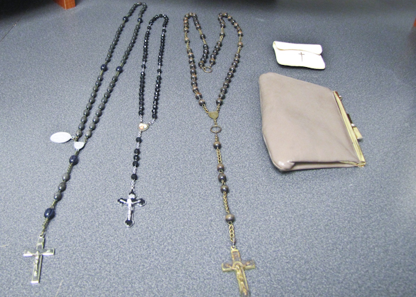 Three vintage rosaries with purse
