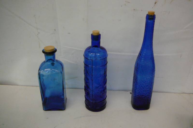 lot 61 image: Blue Glass Bottles 14   11 12   9  High