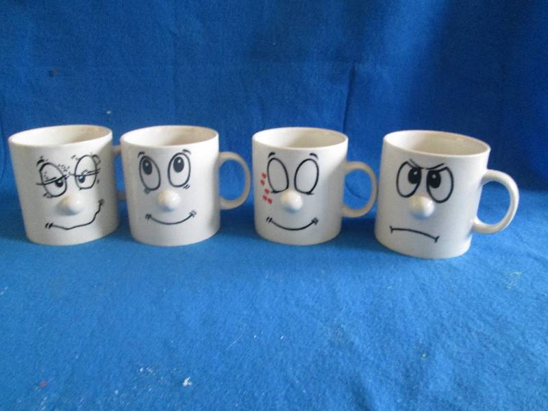 lot of 4 coffee cups with faces ...