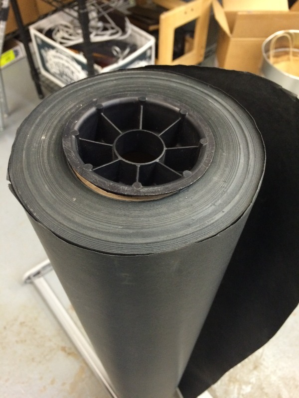 lot 27 image: Roll of Black Paper and dispenser   36 wide