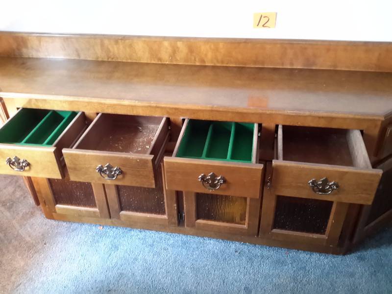 lot 12 image: Breakfront cabinet with 4 drawers and bottom cabinet.  Orange rough surface glass in door front.