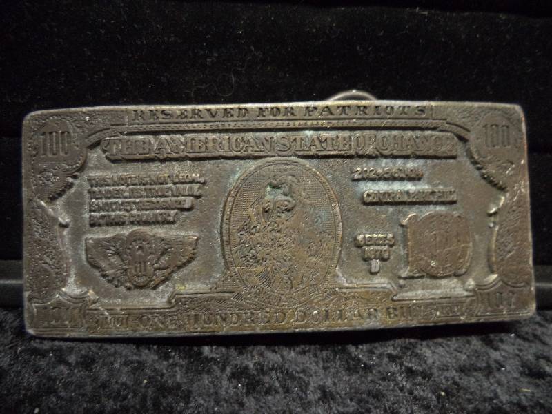 lot 86 image: Belt Buckle - 100 Dollar Bill