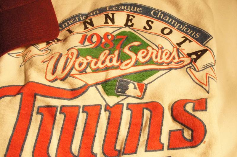 lot 507 image: Collectible Twins Sweatshirt from 1987 World Series, Minnesota Twins T-Shirt from 1987 and Minnesota Golden Gopher Baseball Cap