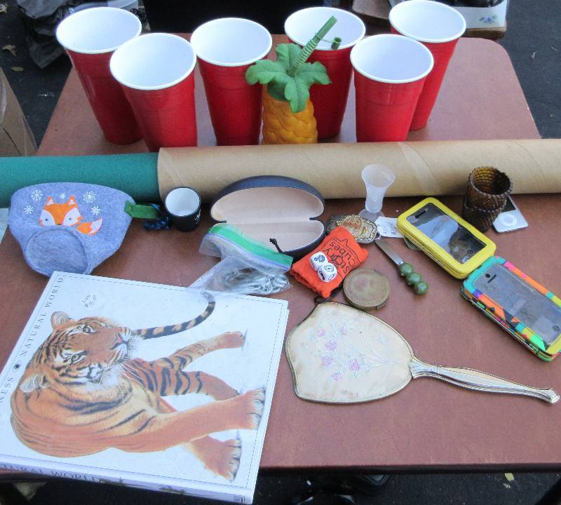lot 703 image: MISC LOT - 6 RED SOLO CUPS, LARGE PUZZLE MAT, HAND MIRROR, CHEESE SPREADER, BOOKS, STORY CUBES, 2 PHONE CASES, IPOD