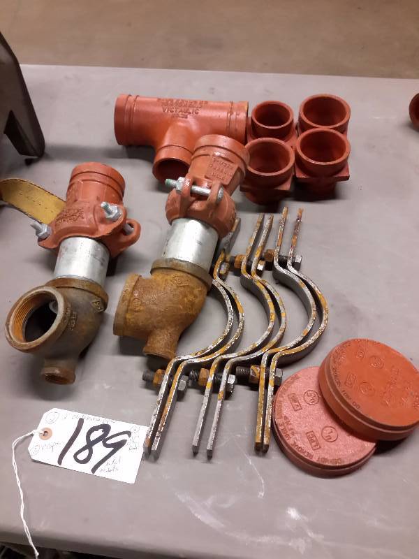 lot 189 image: 2, 2in Vic to Metal pipe converter, 4, 2 12 in Reducers, 2, 4in VIC Caps, Lot of Metal brackets