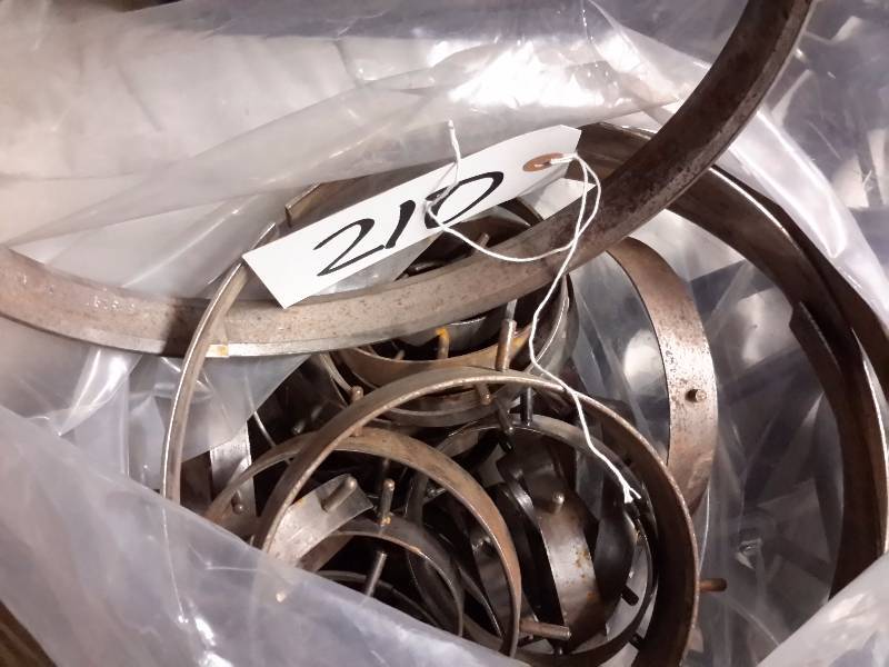 lot 210 image: Bag of rings. Misc. Sizes from 4-12in.  Look like something that would be used in creating a hole when setting cement..   No one seems to know what these are.