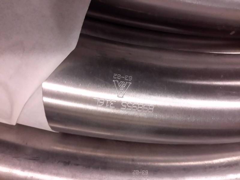 lot 142 image: 7 pieces of 2 12 in  Stainless elbow pipe.. Approx 36in long.. See closeup picture for identification code