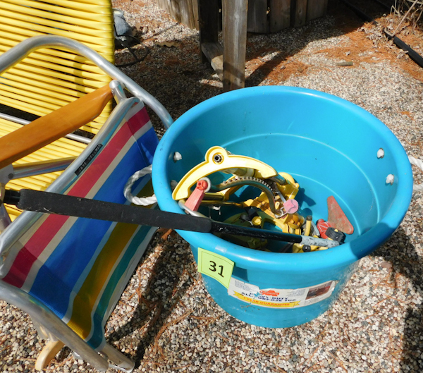 lot 31 image: plastic tote and misc lawn watering devices