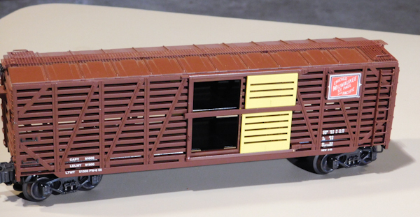 lot 57 image: Model trains, collectible, The Milwaukee Road Brown and Yellow Livestock car