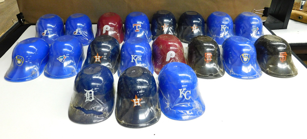 lot 89 image: Several MLB plastic baseball helmets with a few baseball cards included