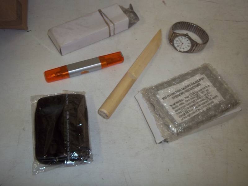 lot 241 image: Talking calculator, book light, watch, screwdriver, and wood knife