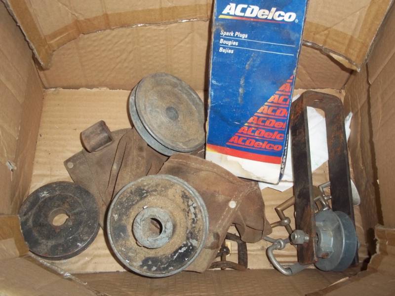 lot 297 image: Pulleys and box of new spark plugs