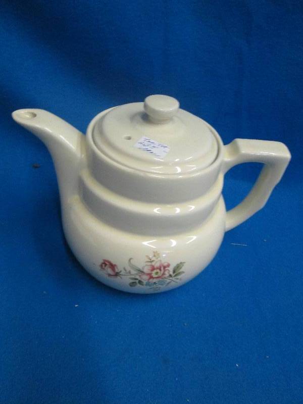 Cream color tea pot with lid and fl...