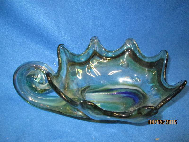 Green glass bowl, inside of curled ...