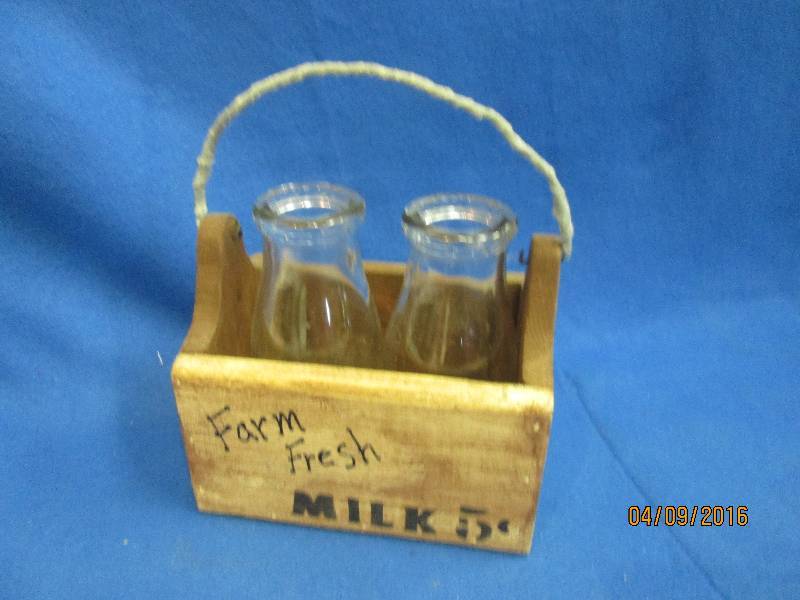 2 milk bottles in a wooden case...
