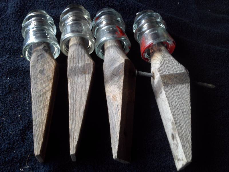 4 VINTAGE GLASS INSULATERS ON ORIGINAL WOOD