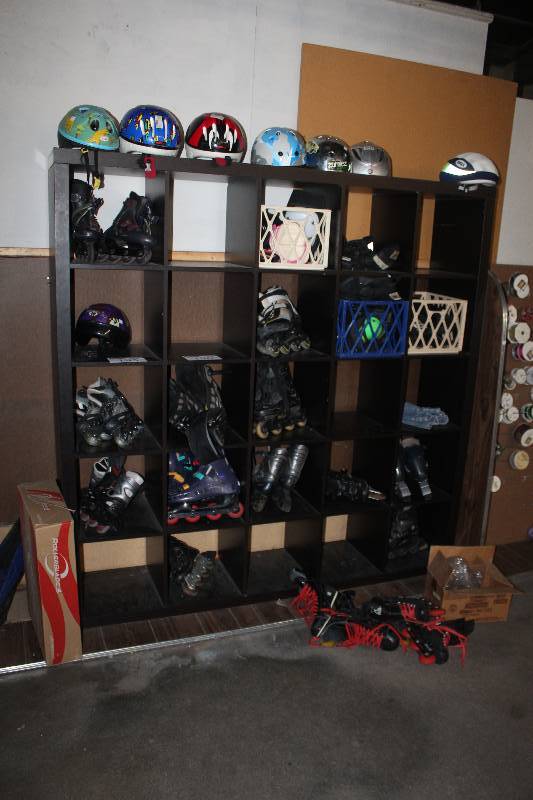 Contents of 5-Shelf Book Case Including Helmets Skates