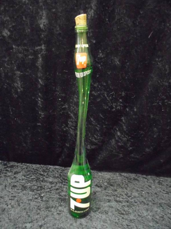 lot 24 image: Vintage 7-Up Stretch Neck Bottle