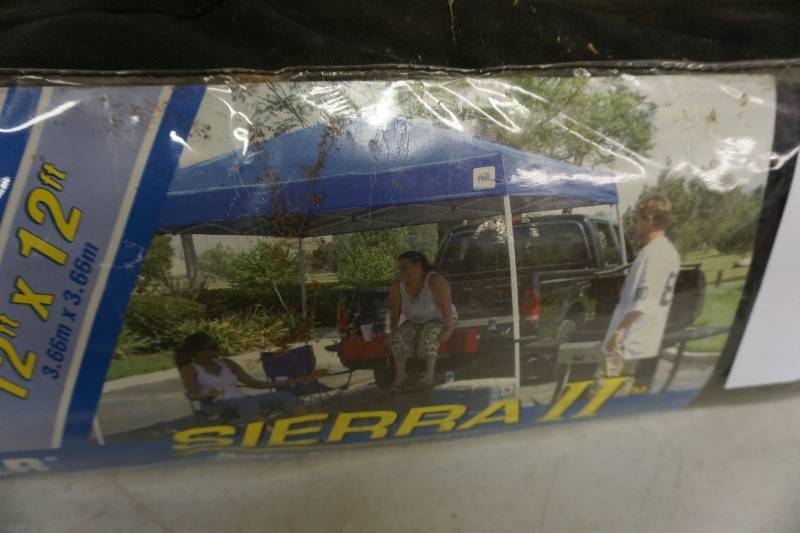 lot 5 image: EZ UP Sierra II 12 x 12 Pop Up Instant Shelter With Wheeled Storage Bag