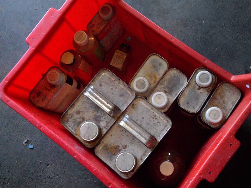 tote full of varnishing and garage supplies