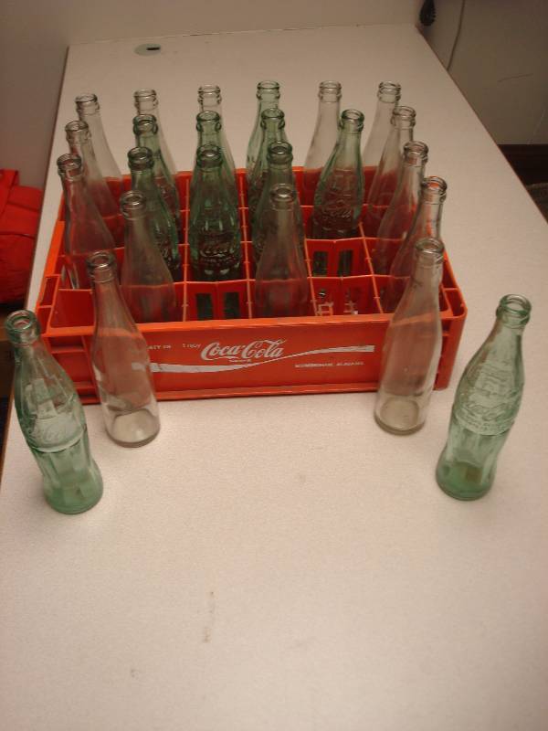 lot 84 image: Plastic Coke Crate With Some Bottles