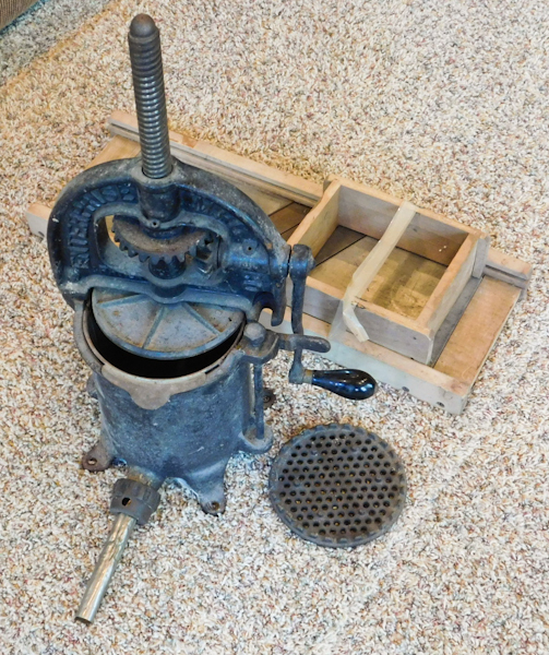 lot 14 image: large vintage cast iron sausage stuffer and cabbage slicer