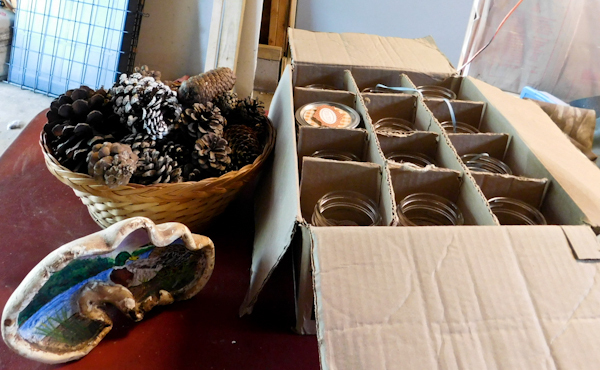 lot 106 image: several canning jars, painted mushroom and basket of pinecones