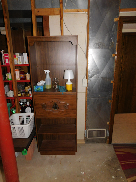 lot 27 image: brown bookshelf with drop down desk