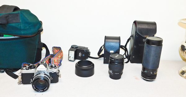 lot 70 image: vintage Nikon camera with bags and lenses