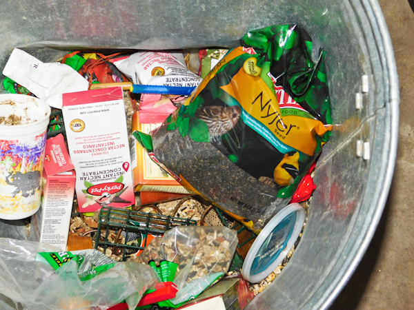 lot 115 image: metal trash can with several bird feeding items