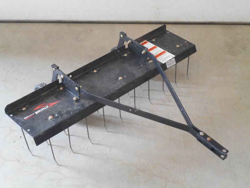 lot 7 image: 40 Brinly Towable Pin-Hitch Lawn De-Thatcher, Like New
