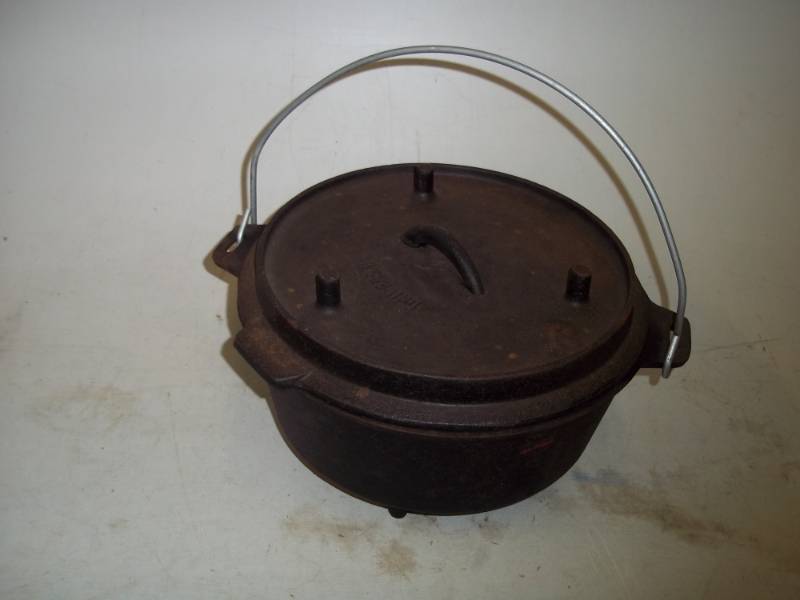 lot 6 image: Cast iron Dutch oven. Lid doubles as griddle.  11 inches