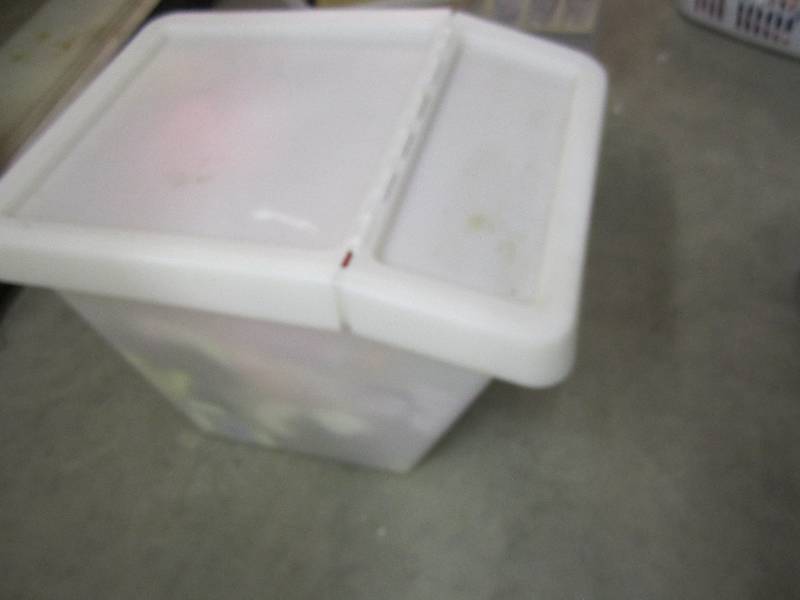 Plastic storage bin filled with toy...