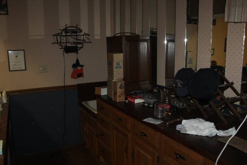 lot 287 image: Contents of Counter and Cabinets Including Odouls Neon Light Cards and Chips Glassware Hats Socks wine Rack Decorations