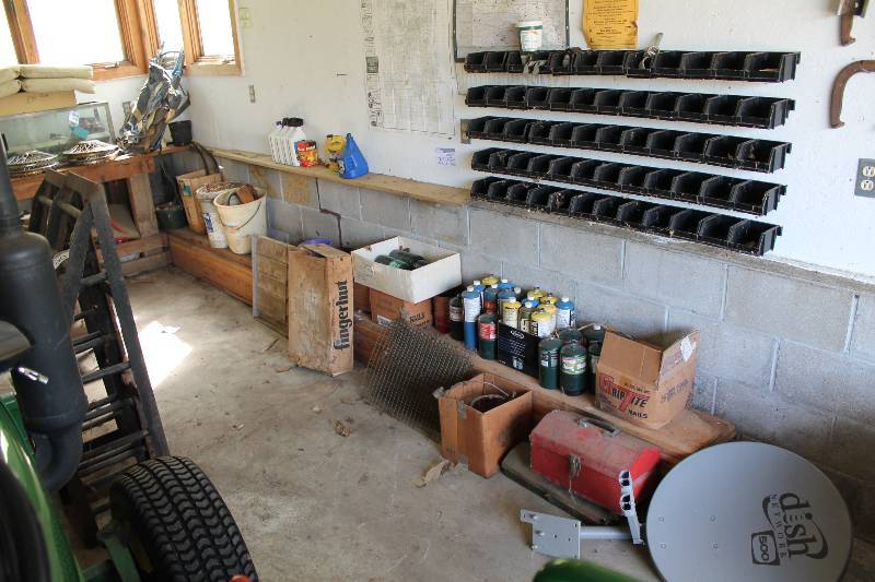 lot 201 image: Contents On and Along Wall Including Car Fluids Yard Sprayer Tools Hardware Dish Satellite Receiver Propane Cans