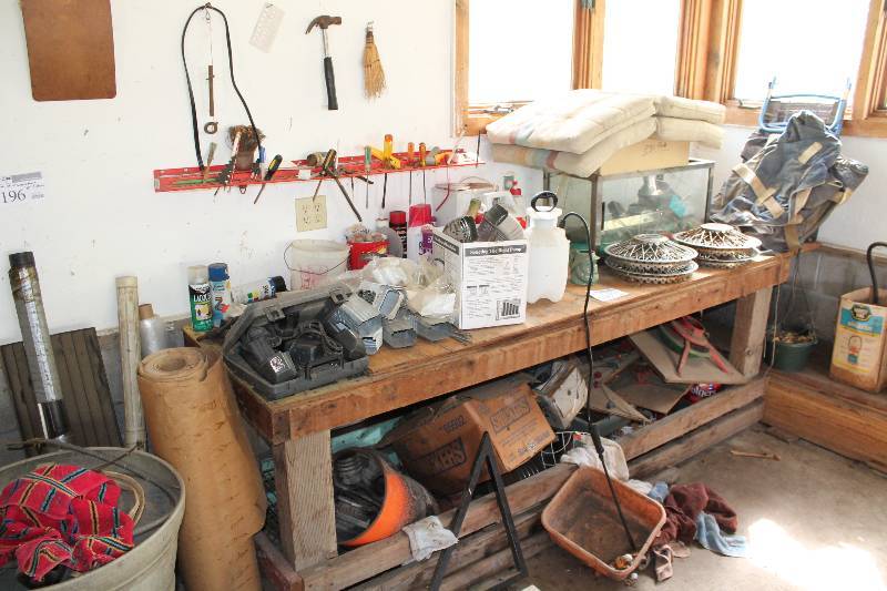 lot 197 image: Contents On, Below and Above Workbench Including Fish Tank Hubcaps Garden Supplies Tools Car Accessories Decorations