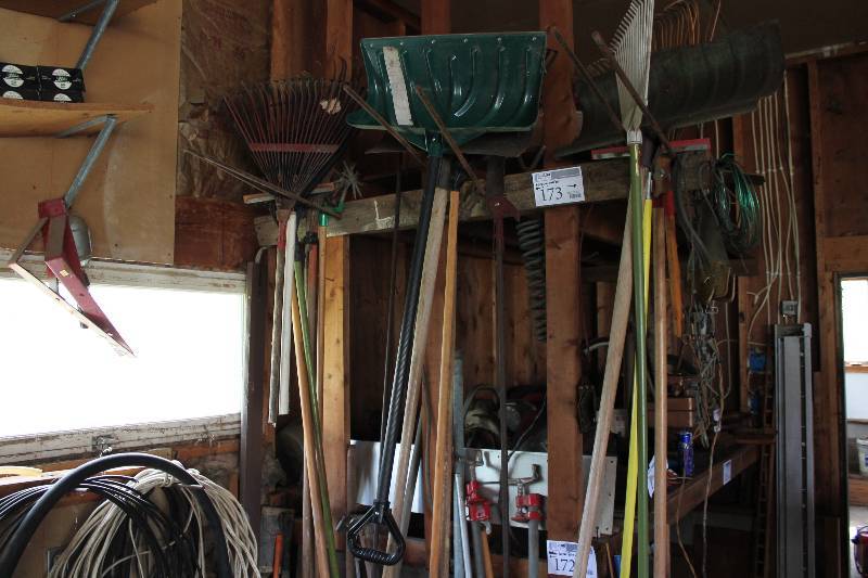 lot 173 image: Hanging Wall Lot of Tools Including Rakes Snow Shovels