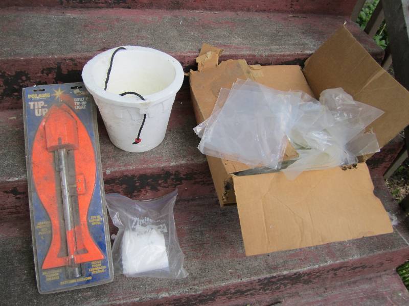 lot 121 image: New tip up, bait pail and box of po...