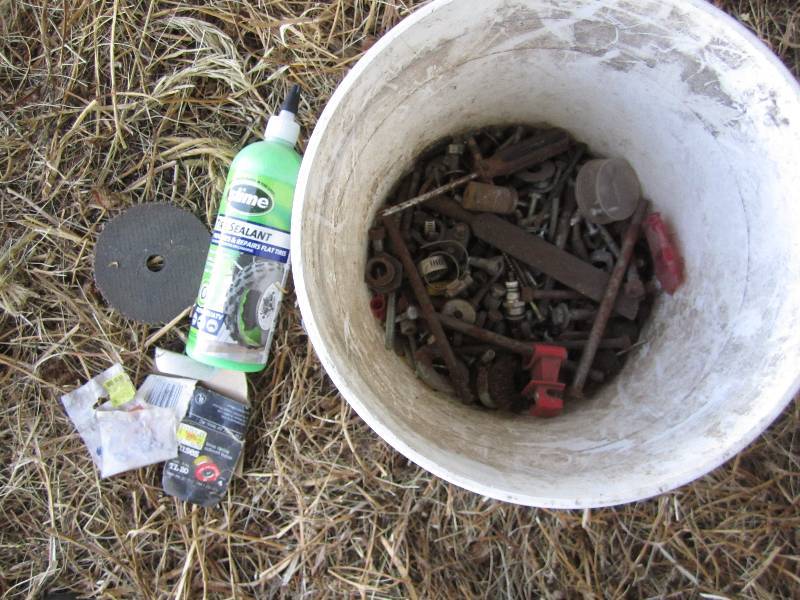 lot 442 image: Bucket of tire sealer, bolts, misc....