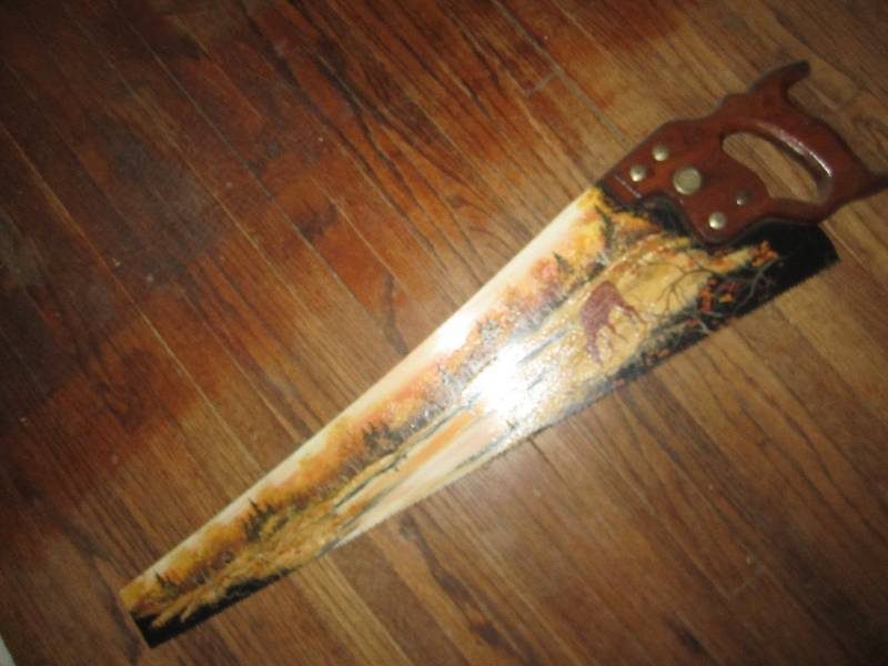 lot 21 image: Deer painted saw...